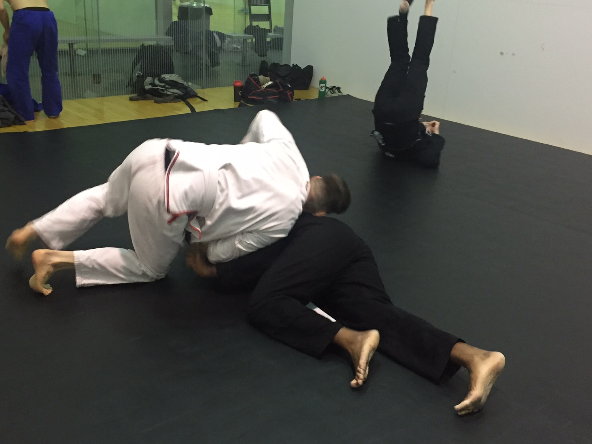 Tech. Sgt. Christopher Elliott, antiterrorism officer, 178th Security Forces Squadron, Springfield Air National Guard Base (left), grapples with Lt. Col.James Finlayson, National Air and Space Intelligence Center, during a Brazilian jiu jitsu class March 17 at Wright Field Fitness Center.