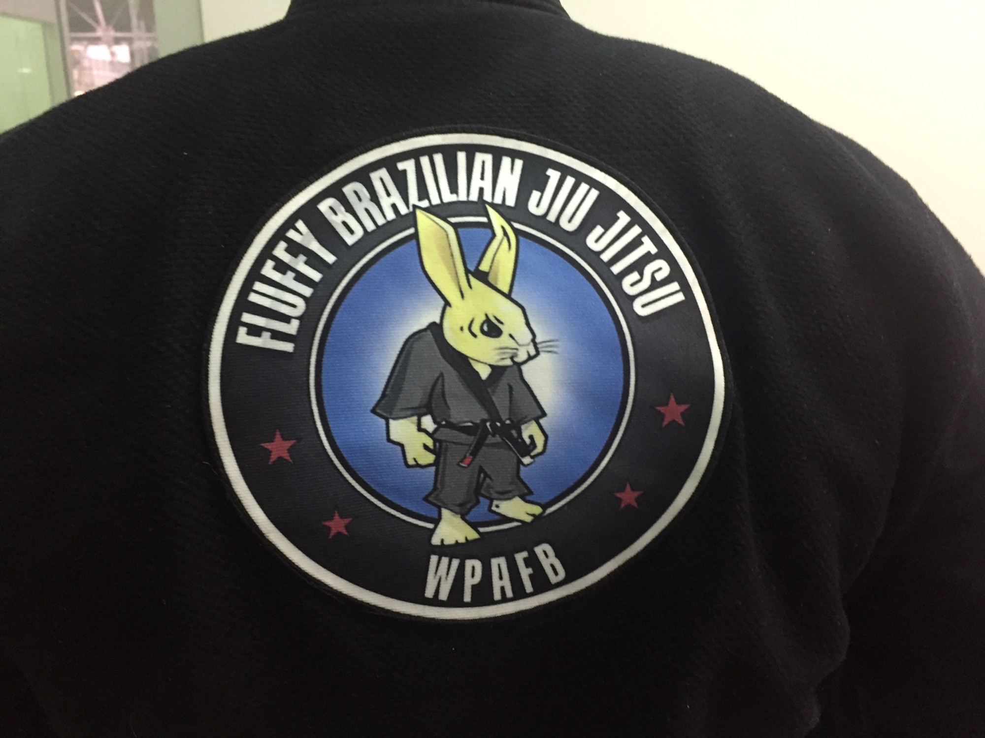 The gi, or traditional belted top, of Lt. Col.James Finlayson, National Air and Space Intelligence Center, reflects the class symbol.(Skywrighter photo/Amy Rollins)