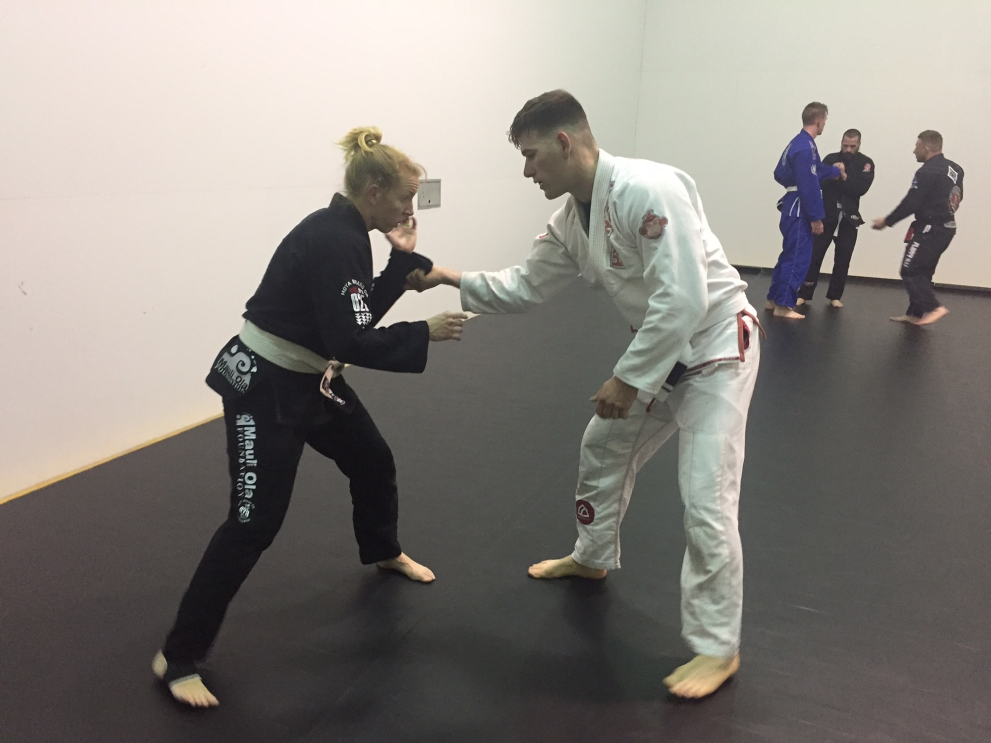 Chelsea Rorer (left), an emergency nurse at Miami Valley Hospital and whose wife is a physician at the Wright-Patterson Medical Center, practices breaking the grip ofTech. Sgt. Christopher Elliott, anti-terrorism officer, 178th Security Forces Squadron, Springfield Air National Guard Base, during the Brazilian jiu jitsu class March 17. (Skywrighter photo/Amy Rollins)
