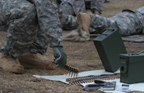 A U.S. Army Reserve Soldier picks up M240B machine gun ammunition for zeroing of ground qualification during Operation Cold Steel at Fort McCoy, Wis., March 25, 2017. Operation Cold Steel is the U.S. Army Reserve's crew-served weapons qualification and validation exercise to ensure that America's Army Reserve units and Soldiers are trained and ready to deploy on short-notice and bring combat-ready and lethal firepower in support of the Army and our joint partners anywhere in the world. (U.S. Army Reserve photo by Staff Sgt. Debralee Best, 84th Training Command)