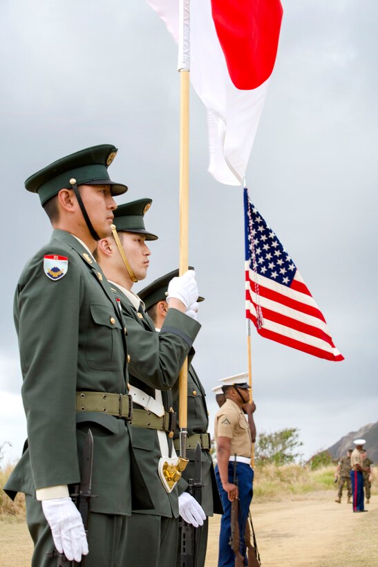 Marines and Japanese color guard teams stand at attention during the 72nd anniversary of the Battle of Iwo Jima at the Reunion of Honor memorial in Iwo To, Japan, March 25, 2017. Marine Corps photo by Lance Cpl. Brooke Deiters