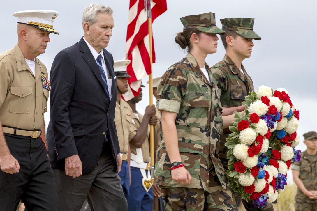 Marine Lt. Gen. David H. Berger, left, commander, U.S. Marine Corps Pacific, retired Marine Corps Lt. Gen. Norman Smith and members of the Young Marines approach an Iwo Jima memorial before participating in a wreath laying presentation as part of the 72nd anniversary of the Battle of Iwo Jima at the Reunion of Honor memorial in Iwo To, Japan, March 25, 2017. Marine Corps photo by Lance Cpl. Brooke Deiters