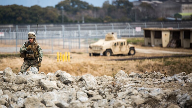 Gunnery Sgt. Ysac Perez, the air base ground defense staff non-commissioned officer in charge for Marine Wing Support Squadron 171, observes how Marines deal with the set objectives during Exercise Tanuki Wrath on Marine Corps Air Station Iwakuni, Japan, March 22, 2017. MWSS-171 conducted the exercise to help train Marines to set up security around a downed aircraft and how to control a riot.