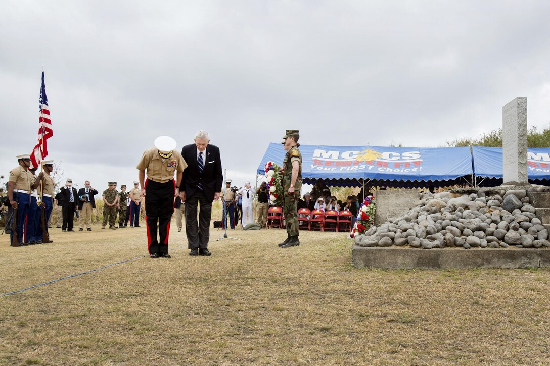 Marine Lt. Gen. David H. Berger, left, commander, U.S. Marine Corps Pacific, and retired Marine Corps Lt. Gen Norman Smith bow to their Japanese counterparts after laying a wreath at an Iwo Jima memorial as part of the 72nd anniversary of the Battle of Iwo Jima at the Reunion of Honor memorial in Iwo To, Japan, March 25, 2017. Marine Corps photo by Lance Cpl. Brooke Deiters