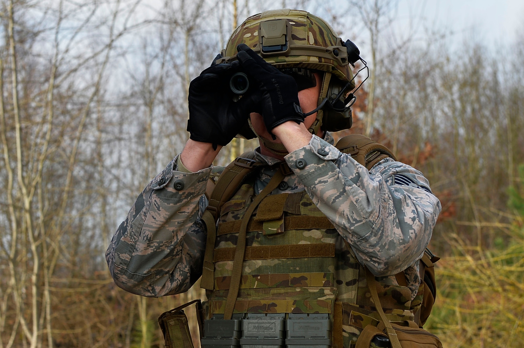 Tech. Sgt. Aaron Carroll, 786th Civil Engineer Squadron NCO in charge if explosive ordnance supply, looks through a monocular during an exercise on Ramstein Air Base, Germany, March 23, 2017. 2017 Marked the first time in nine years EOD was included in the Silver Flag curriculum at Ramstein. The 435th Contingency Response Group holds the exercise year-round. (U.S. Air Force photo by Airman 1st Class Joshua Magbanua)