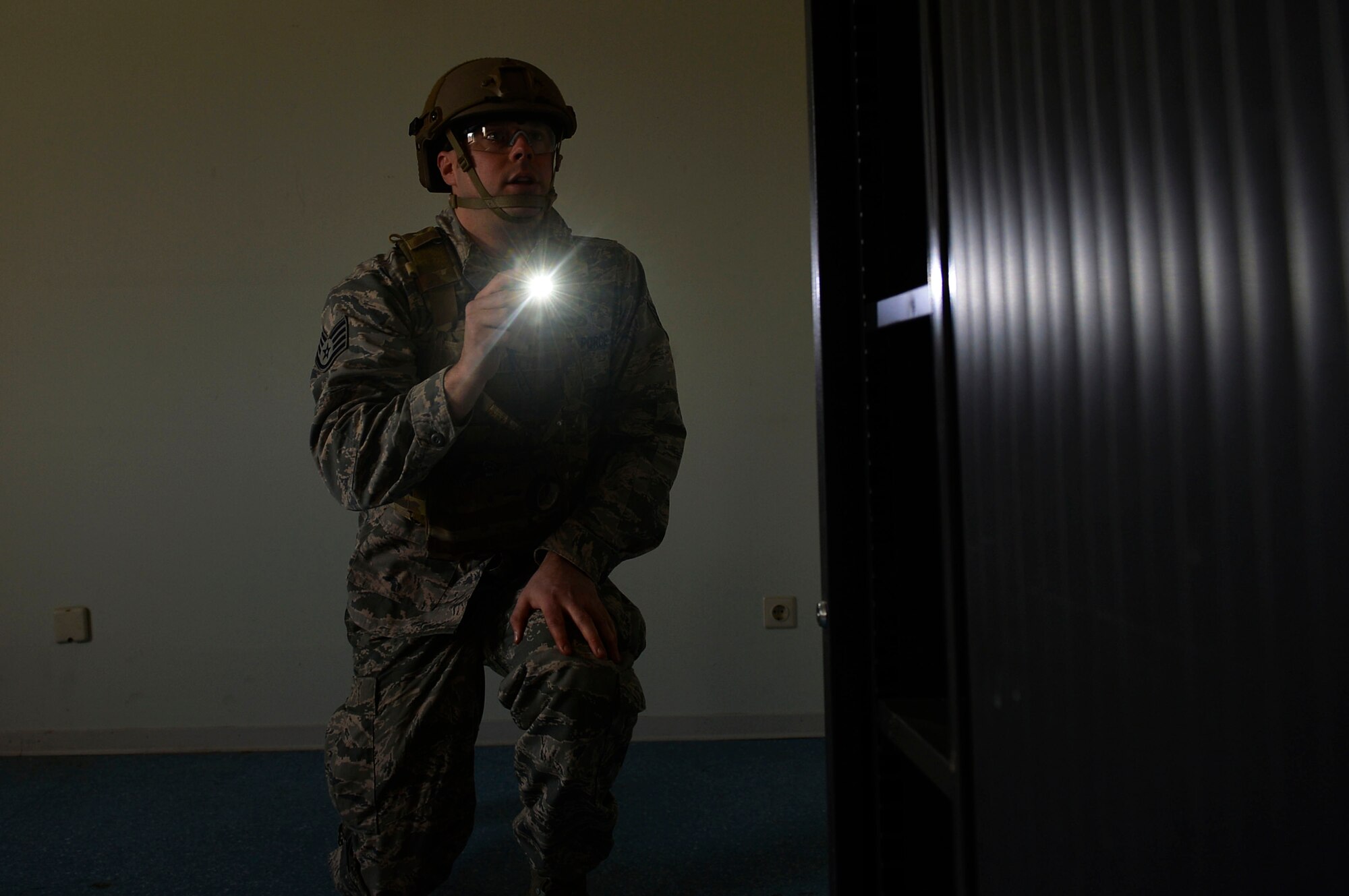 Staff Sgt. Brook Hamilton, 52nd Civil Engineer Squadron explosive ordnance disposal craftsman, performs a clearing operation in a building during an exercise on Ramstein Air Base, Germany, March 23, 2017. The operation took place in newly established training ground, which featured a mock-village where various scenarios could take place. Exercise Silver Flag takes place more than once a year, and is hosted by the 435th Contingency Response Group. (U.S. Air Force photo by Airman 1st Class Joshua Magbanua)