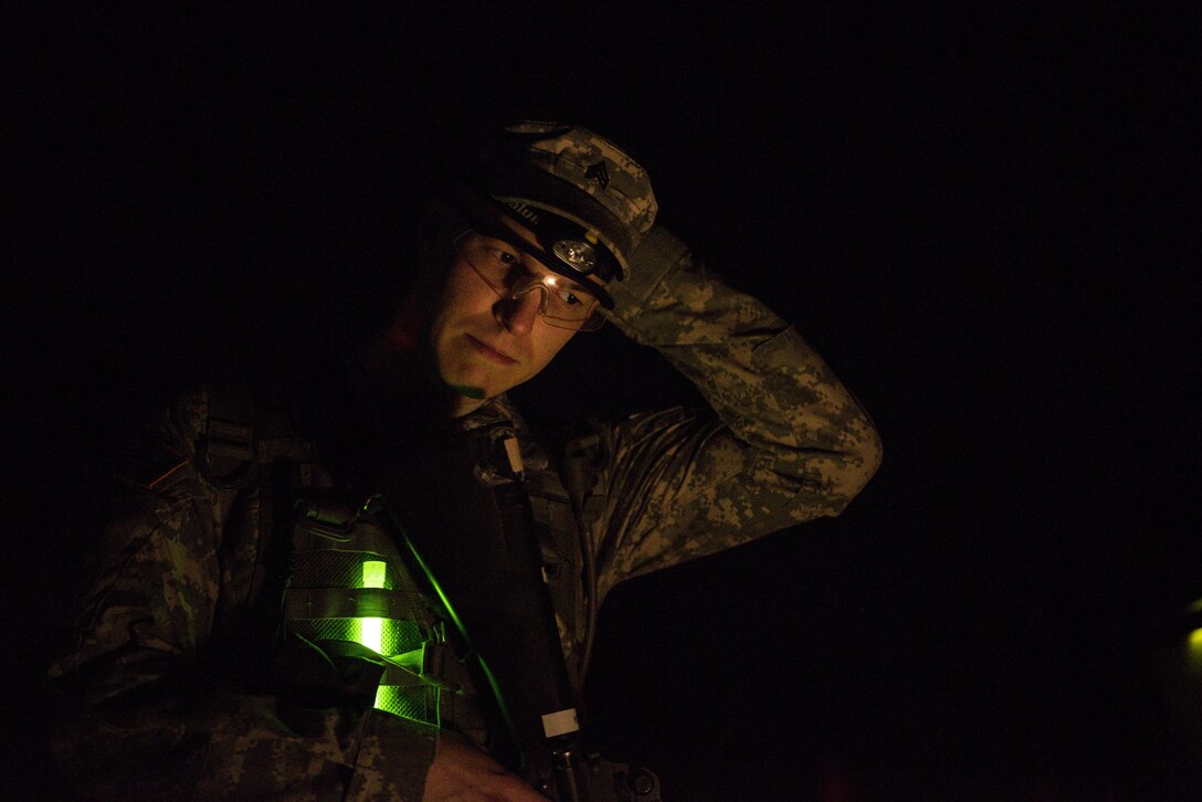 With only the moon light, red flash lights and glow sticks, Sgt. Jordan Lepley representing the 290th Military Police Brigade, puts his night land navigation skills to the test at this year’s 200th Military Police Command’s Best Warrior Competition held at Fort Hunter Liggett, Calif., March 17, 2017. Competitors tested their Army aptitude by completing warfare simulations, board interviews, physical fitness tests, written exams, and Warrior tasks and battle drills. (US Army photo by Sgt. Elizabeth Taylor)