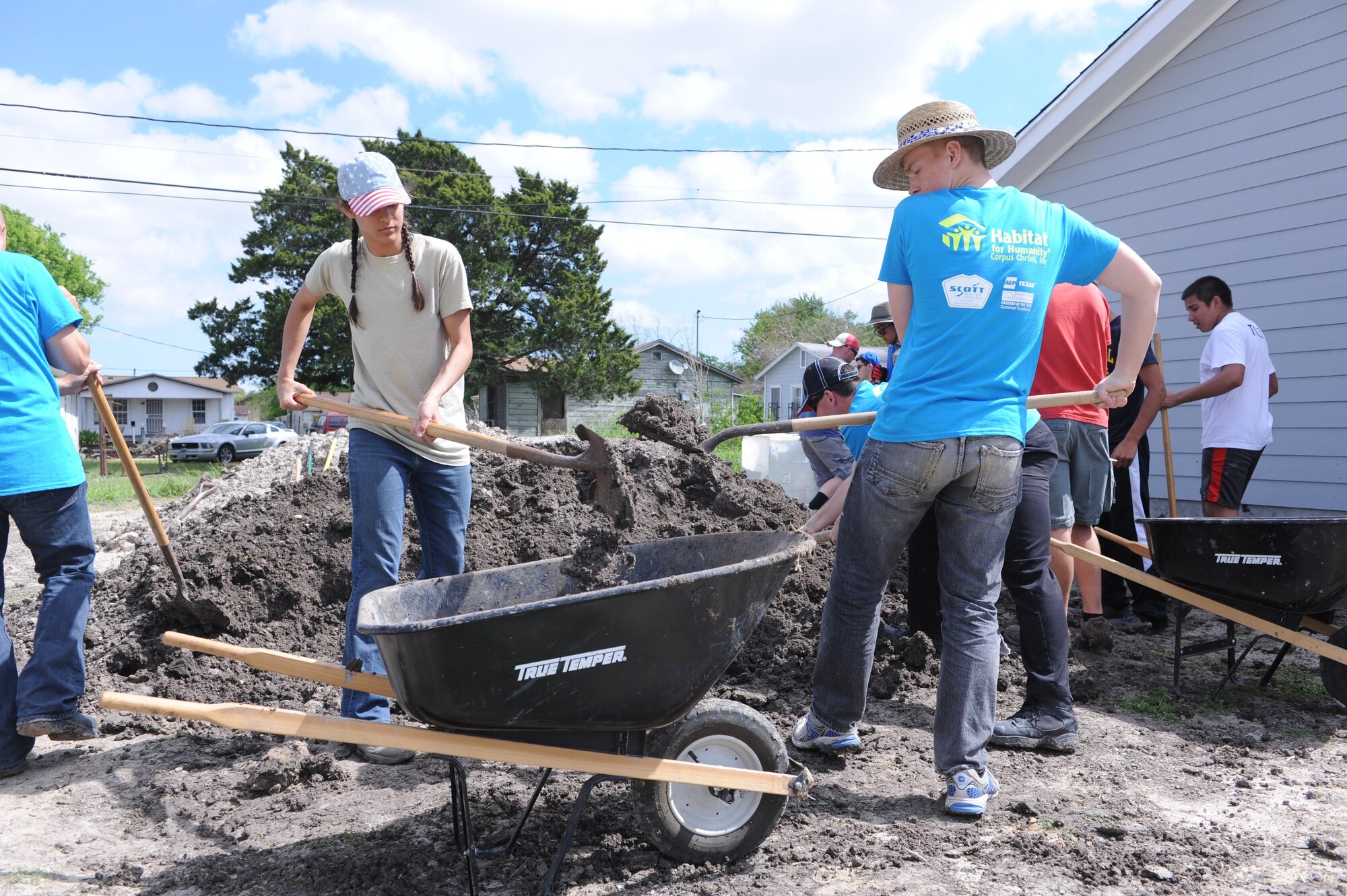 Then-Cadet 2nd Class Leah Gates (left) and then-Cadet 4th Class Luke Robinson shovel dirt into a wheelbarrow  in Corpus Christi, Texas, March 22, 2016, during an Alternate Spring Break Program volunteer effort with Habitat for Humanity. (Air Force photo/John Van Winkle) 
