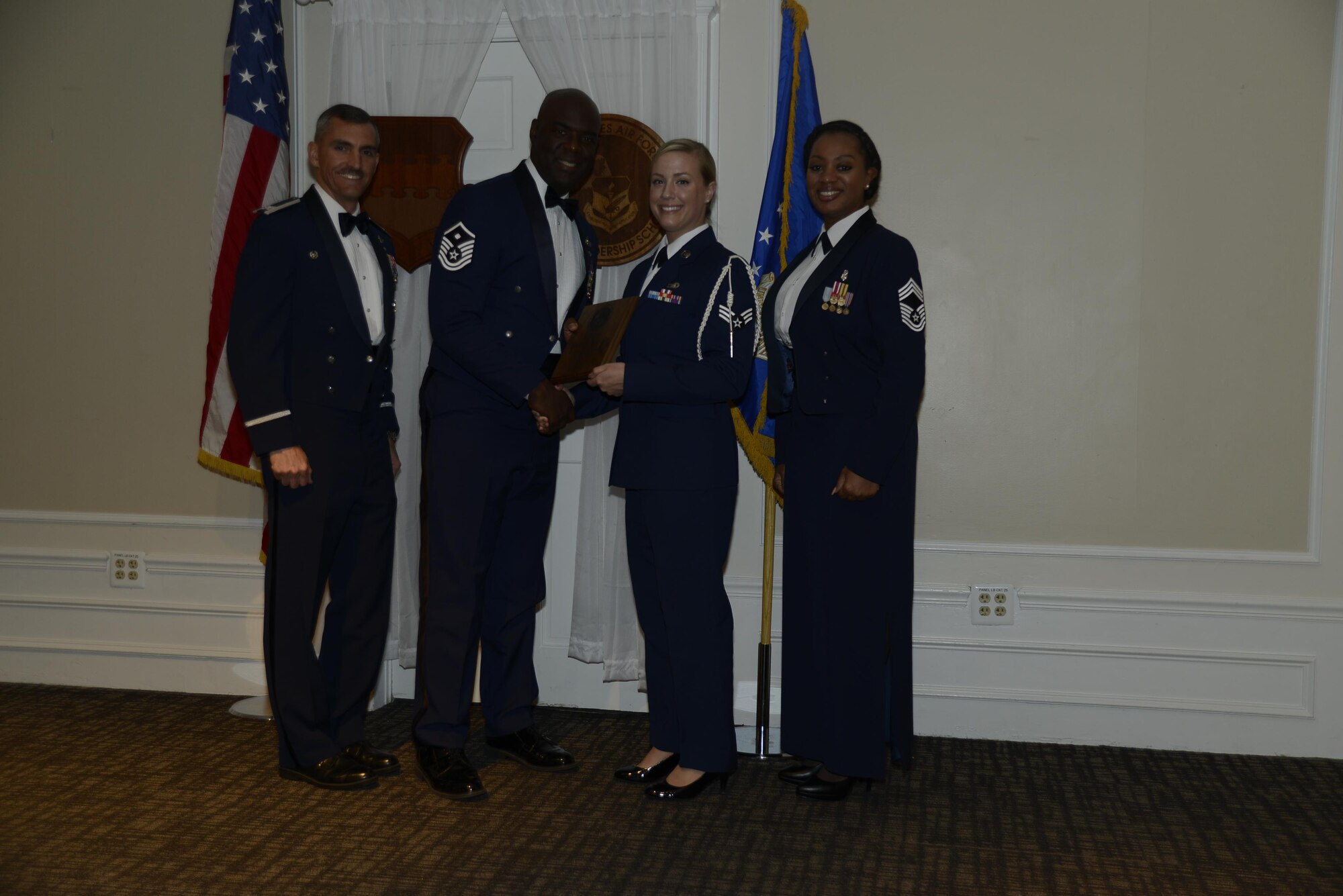 U.S. Air Force Senior Airman Christine L. Teegarden, 31st Intelligence Squadron, receives the Senior Master Sgt. David B. Reid Airman Leadership School Academic Achievement award during the ALS Class 17-3 graduation ceremony at Shaw Air Force Base, S.C., March 23, 2017. This award is given to the student with the highest point total. (U.S. Air Force photo by Airman 1st Class BrieAnna Stillman)