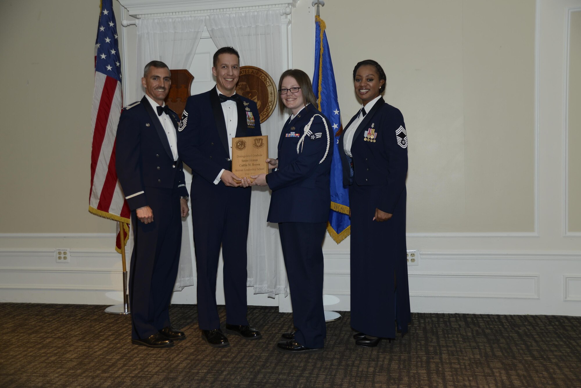 U.S. Air Force Senior Airman Caitlin M. Brown, 3rd Intelligence Squadron, receives a distinguished graduate award during the Senior Master Sgt. David B. Reid Airman Leadership School Class 17-3 graduation ceremony at Shaw Air Force Base, S.C., March 23, 2017. Distinguished graduate awards are given to the top 10 percent of the class for total point accumulation. (U.S. Air Force photo by Airman 1st Class BrieAnna Stillman)