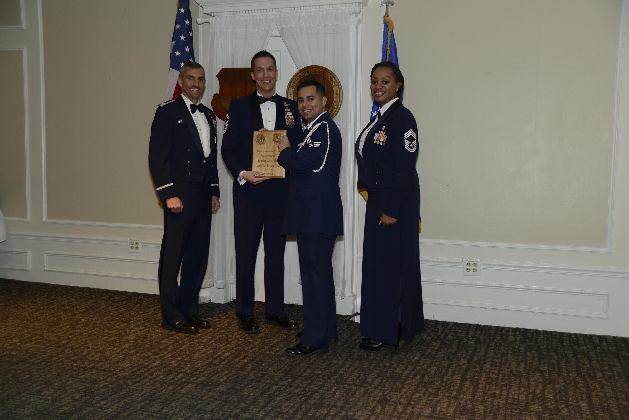 U.S. Air Force Senior Airman Bradley J. Harding, 31st Intelligence Squadron, receives a distinguished graduate award during the Senior Master Sgt. David B. Reid Airman Leadership School Class 17-3 graduation ceremony at Shaw Air Force Base, S.C., March 23, 2017. Distinguished graduate awards are given to the top 10 percent of the class for total point accumulation. (U.S. Air Force photo by Airman 1st Class BrieAnna Stillman)
