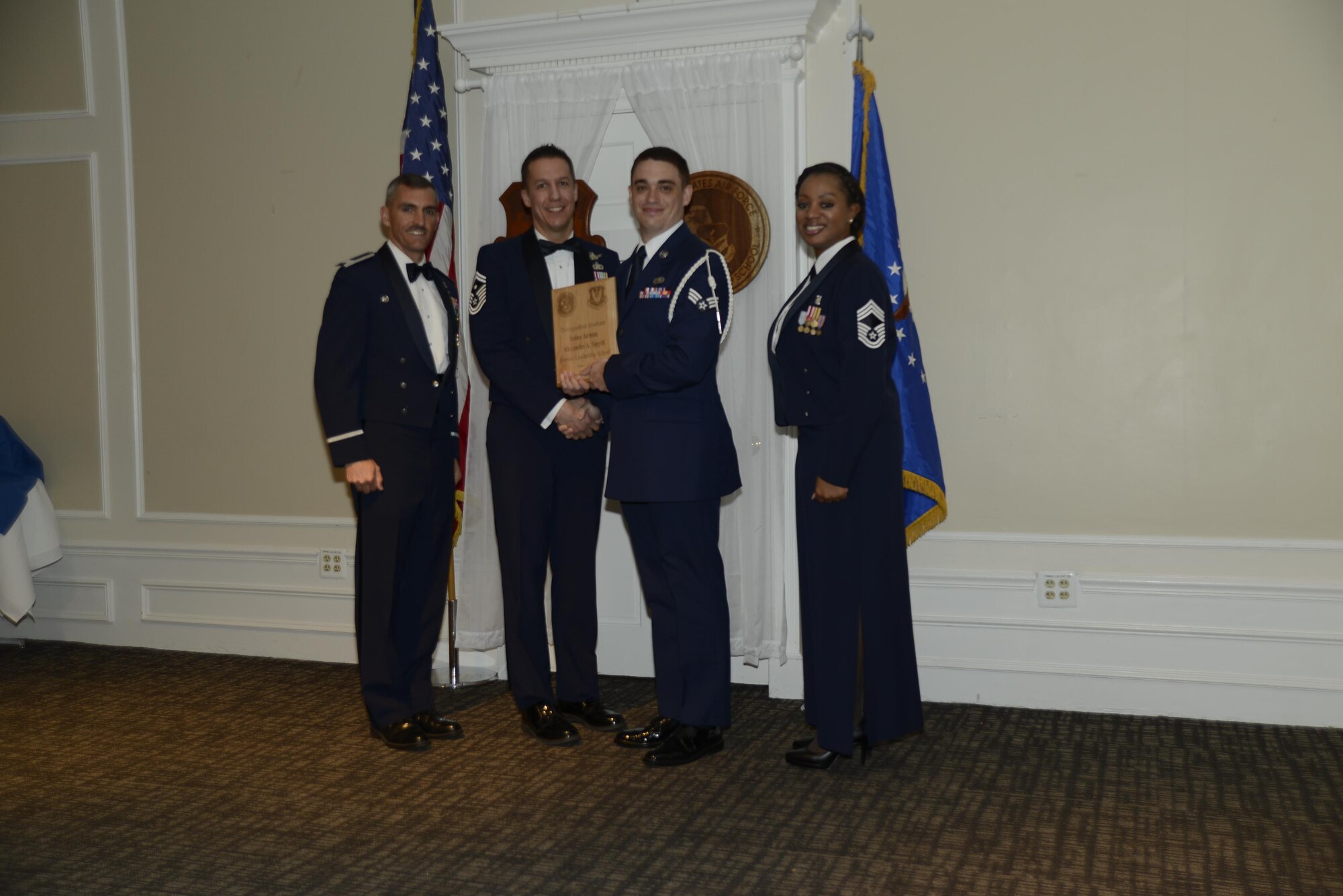 U.S. Air Force Senior Airman Alexander A. Smyth, 3rd Intelligence Squadron, receives a distinguished graduate award during the Senior Master Sgt. David B. Reid Airman Leadership School Class 17-3 graduation ceremony at Shaw Air Force Base, S.C., March 23, 2017. The distinguished graduate awards are given to the top 10 percent of the class for total point accumulation. (U.S. Air Force photo by Airman 1st Class BrieAnna Stillman)
