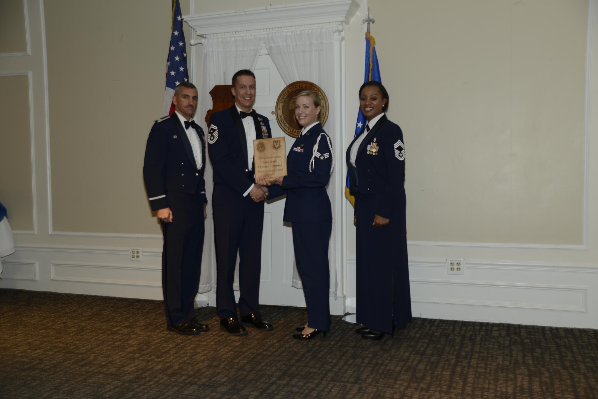 U.S. Air Force Senior Airman Christine L. Teegarden, 31st Intelligence Squadron, receives a distinguished graduate award for the Senior Master Sgt. David B. Reid Airman Leadership School Class 17-3, at Shaw Air Force Base, S.C., March 23, 2017. The distinguished graduate awards are given to the top 10 percent of the class for total point accumulation. (U.S. Air Force photo by Airman 1st Class BrieAnna Stillman)
