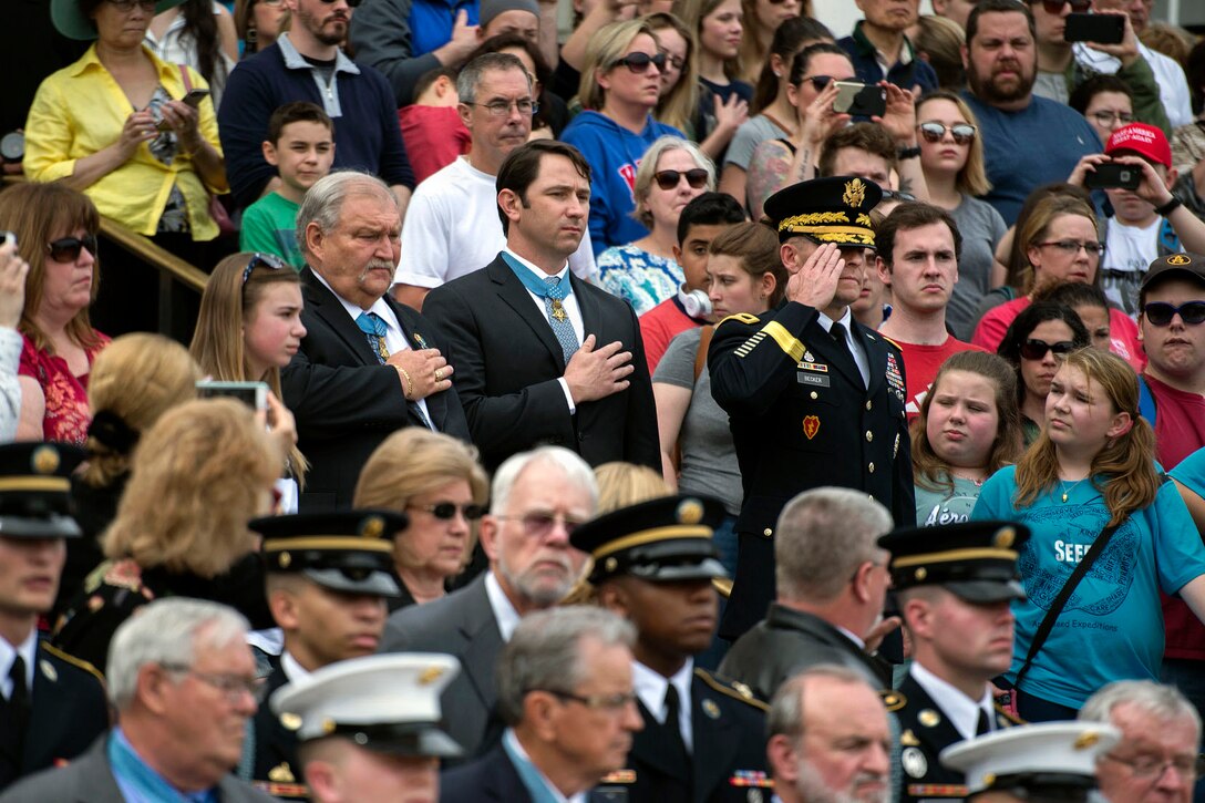 Medal of Honor recipients Army veteran Mike Fitzmaurice and Capt. Will Swenson render honors alongside Maj. Gen. Bradley A. Becker during a Medal of Honor Day wreath-laying ceremony at Arlington National Cemetery in Arlington, Va., March 24, 2017. Becker is the commander of Joint Force Headquarters National Capital Region and the U.S. Army Military District of Washington. DoD photo by EJ Hersom