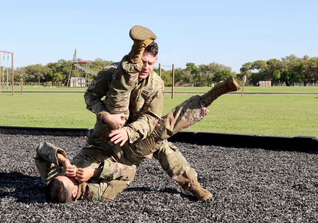 Army Reserve Sgt. 1st Class Farley Thompson, a Tyrone, Ga. native and drill sergeant with Bravo Company, 3rd Battalion, 485th Infantry Regiment, 98th Training Division (Initial EntryTraining), which is located at Fort Benning, Ga., demonstrates level one combatives on an opponet during the 2017 108th Training Command (IET) Drill Sergeant of the Year Competition at Camp Bullis, Texas, March 20, 2017. (U.S. Army Reserve photo by Maj. Michelle Lunato/released)