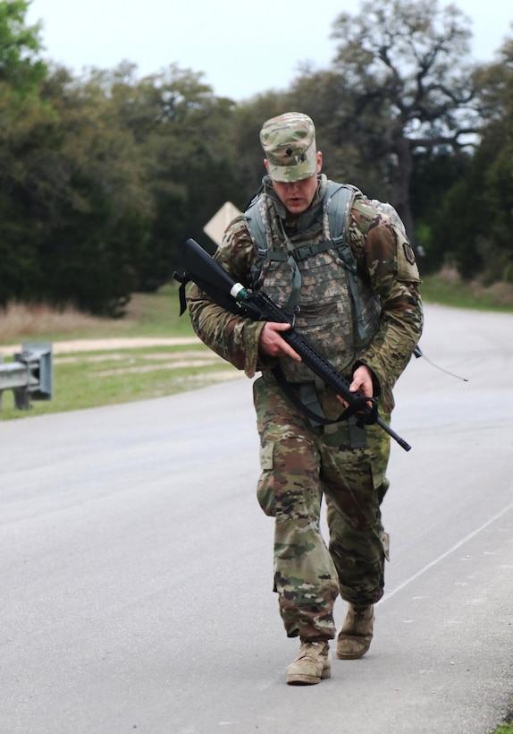 Army Reserve Spc. Keith Rhodes, a Greenville, N.Y. native and a drill sergeant candidate with Bravo Company, 1-304th Infantry Regiment, 4th Brigade, 98th Training Division (Initial Entry Training), reaches the half-way point of his 10k road march during the 108th Training Command (IET) 2017 Best Warrior Competition at Camp Bullis, Texas, March 21, 2017. Rhodes won the Soldier of the Year title for the 98th Training Division (IET). (U.S. Army Reserve photo by Maj. Michelle Lunato/released)