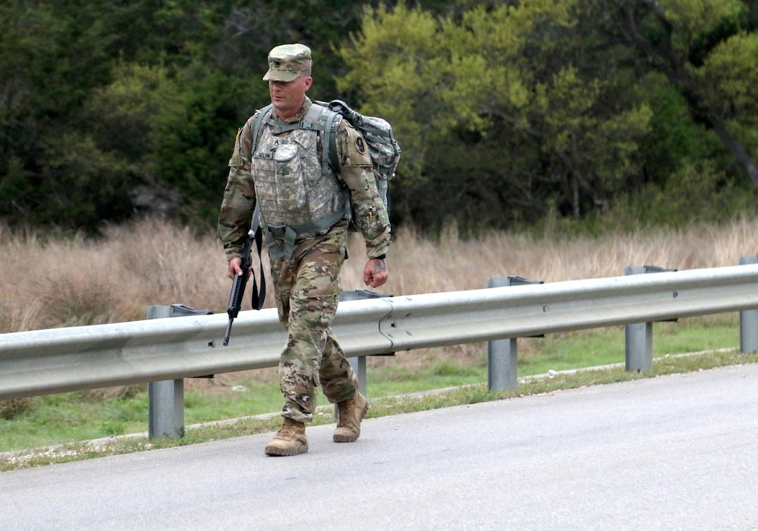 Army Reserve Staff Sgt. Nicholas Smolen, a Manitowoc, Wis. native and radiology specialist with Bravo Company, 1st Battalion, 334th Infantry Regiment (Training Support Battalion), 95th Training Division (Initial Entry Training), reaches the half-way point of his 10k road march during the 108th Training Command (IET) Best Warrior Competition at Camp Bullis, Texas, March 19-24, 2017. Smolen was inspired to serve in the military by his grandfater who served in WWII and was awarded the Purple Heart. (U.S. Army Reserve photo by Maj. Michelle Lunato/released.)