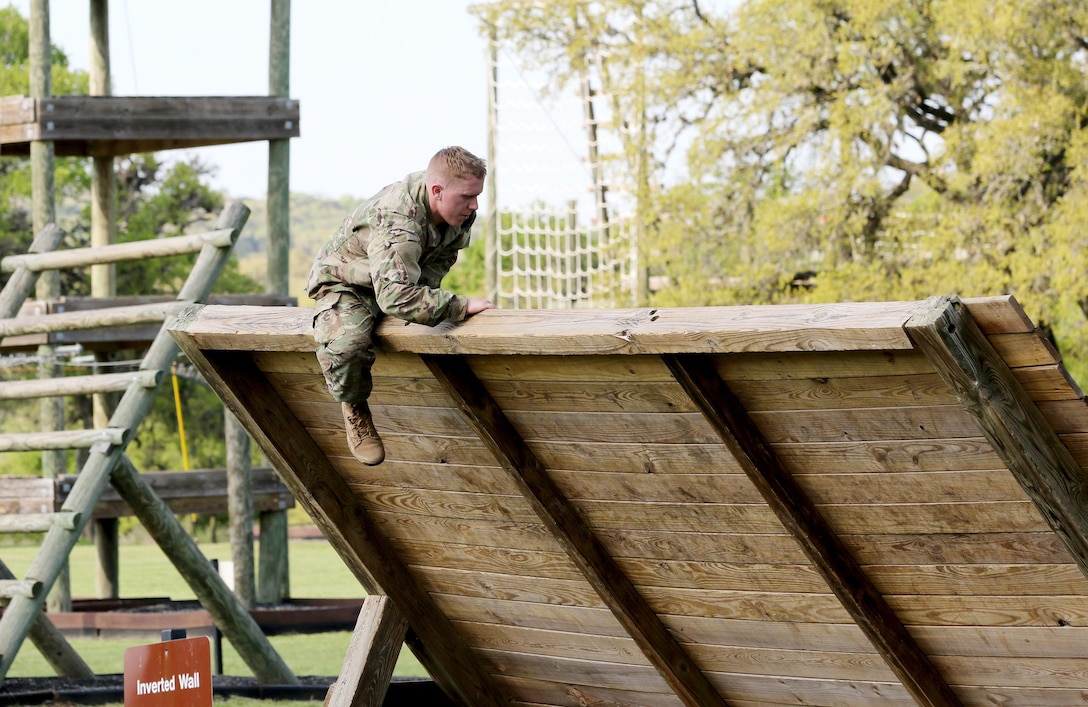 Army Reserve Staff Sgt. Adam Bacon, a Davisburg, Mich. native and infantryman with 334th Infantry Regiment, 1st Battalion, 3rd Brigade, 95th Training Division (Initial Entry Training), manuevers over an inverted wall obstacle at Camp Bullis March 21, 2017 as part of the 108th Training Command (IET) 2017 Best Warrior Competition. As a Citizen-Soldier, Bacon is honored to be "a part of a community that is willing to deploy and leave loved ones behind when the country is in need of assistance." (U.S. Army Reserve photo by Maj. Michelle Lunato/released)