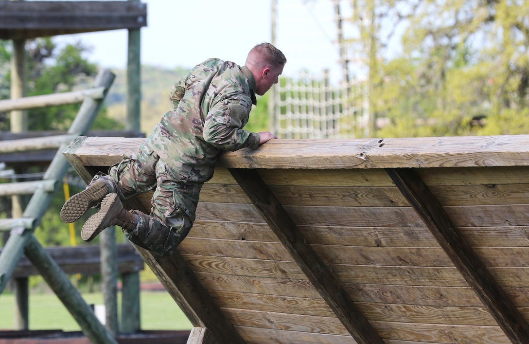 Army Reserve Staff Sgt. Adam Bacon, a Davisburg, Mich. native and infantryman with 334th Infantry Regiment, 1st Battalion, 3rd Brigade, 95th Training Division (Initial Entry Training), manuevers over an inverted wall obstacle at Camp Bullis, Texas, March 21, 2017 as part of the 108th Training Command (IET) 2017 Best Warrior Competition. As a Citizen-Soldier, Bacon is honored to be "a part of a community that is willing to deploy and leave loved ones behind when the country is in need of assistance." (U.S. Army Reserve photo by Maj. Michelle Lunato/released)