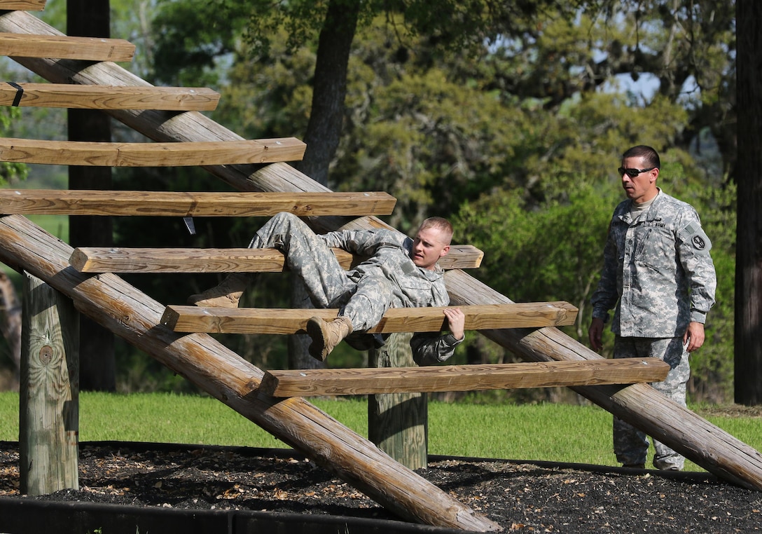 Army Reserve Sgt. Ryan Pritchett, a Wilmore, Ken. native and drill sergeant with Delta Company, 2-397th, 2nd Brigade, 104th Training Division (LT), navigates an obstacle during the 108th Training Command (IET) 2017 Best Warrior Competition at Camp Bullis, Texas, March 19-24.  Pritchett won the title of 2017 Noncommissioned Officer of the Year for the 104th Training Division (LT). (U.S. Army Reserve Photo by Maj. Michelle Lunato/released)