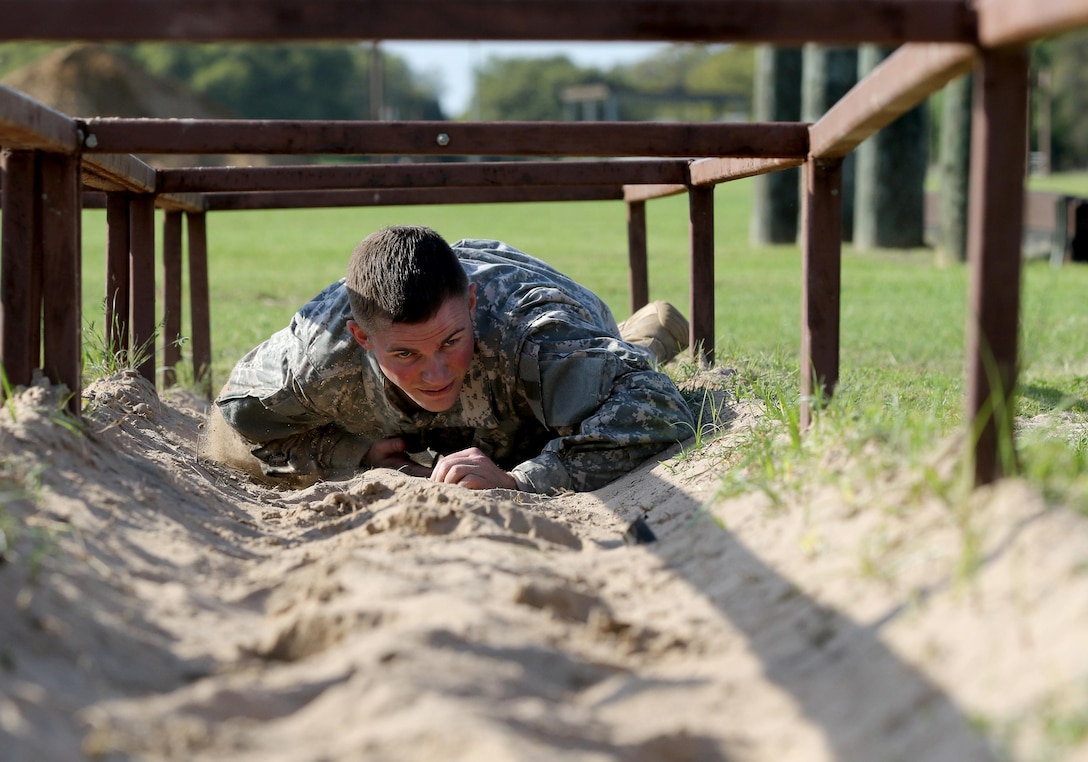 Army Reserve Staff Sgt. Jonathan Davis with the 104th Training Division (LT) completes the low-crawl obstacle during the 108th Training Command (IET) Best Warrior Competition at Camp Bullis, Texas, March 19-24, 2017.  (U.S. Army Reserve photo by Maj. Michelle Lunato.)