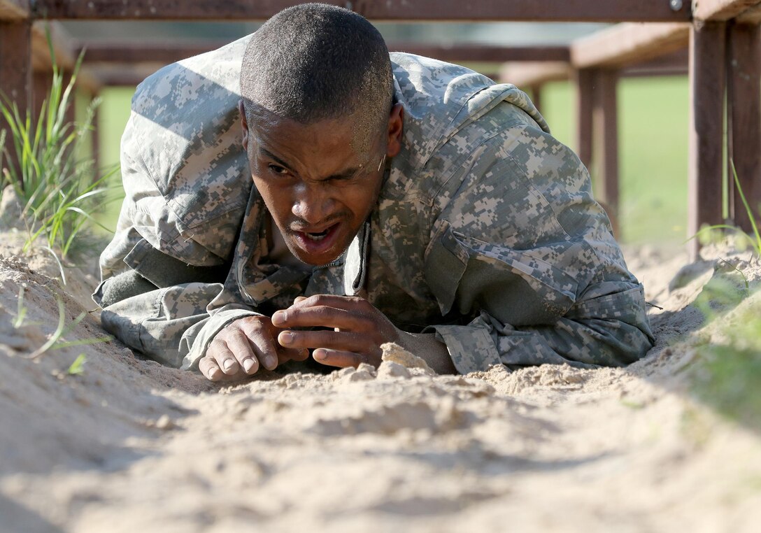 Army Reserve Spc. Michael Parrish Jr., a Petersburg, Virg. native and human resources specialist with Alpha Company, 2-319th, 104th Training Division (LT), completes the low-crawl obstacle during the 108th Training Command (IET) Best Warrior Competition at Camp Bullis, Texas, March 19-24, 2017. Parrish earned the title of 2017 Soldier of the Year for the 104th Training Division (LT).  (U.S. Army Reserve photo by Maj. Michelle Lunato.)