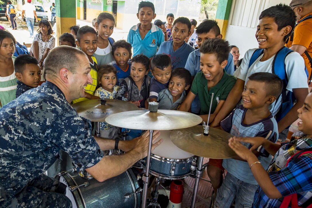 Navy Petty Officer 1st Class Christopher Pastin plays with children during a school visit to support Continuing Promise 2017 in Mayapo, Colombia, March 22, 2017. Pastin is a drummer assigned to U.S. Fleet Forces. The civil-military effort includes humanitarian assistance, training engagements, and medical, dental and veterinary aid to show U.S. support and commitment to Central and South America. Navy photo by Petty Officer 2nd Class Shamira Purifoy