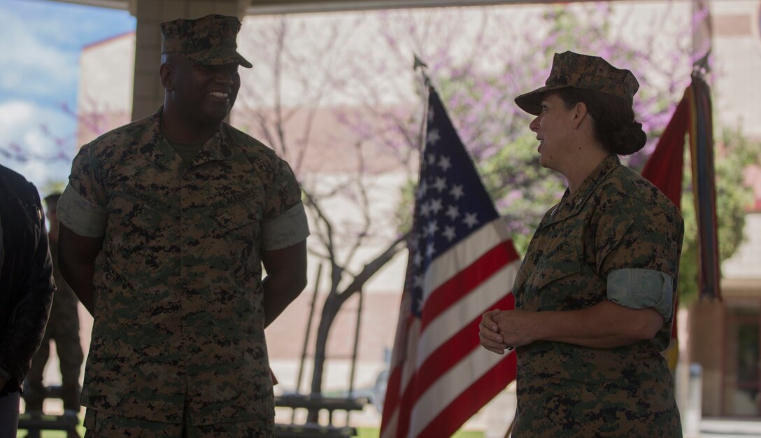 Col. Roberta Shea (right), commanding officer, I Marine Expeditionary Force Headquarters Group, speaks to Marines with I MEF about the career of Sgt. Maj. Alfred R. Broadus (left), Recruiting Station sergeant major, RS Orlando, Fla., during his reenlistment ceremony at Marine Corps Base Camp Pendleton, Calif., March 22, 2017. Broadus will have served 30 years at the end of this enlistment. (U.S. Marine Corps photo by Lance Cpl. A. J. Van Fredenberg)