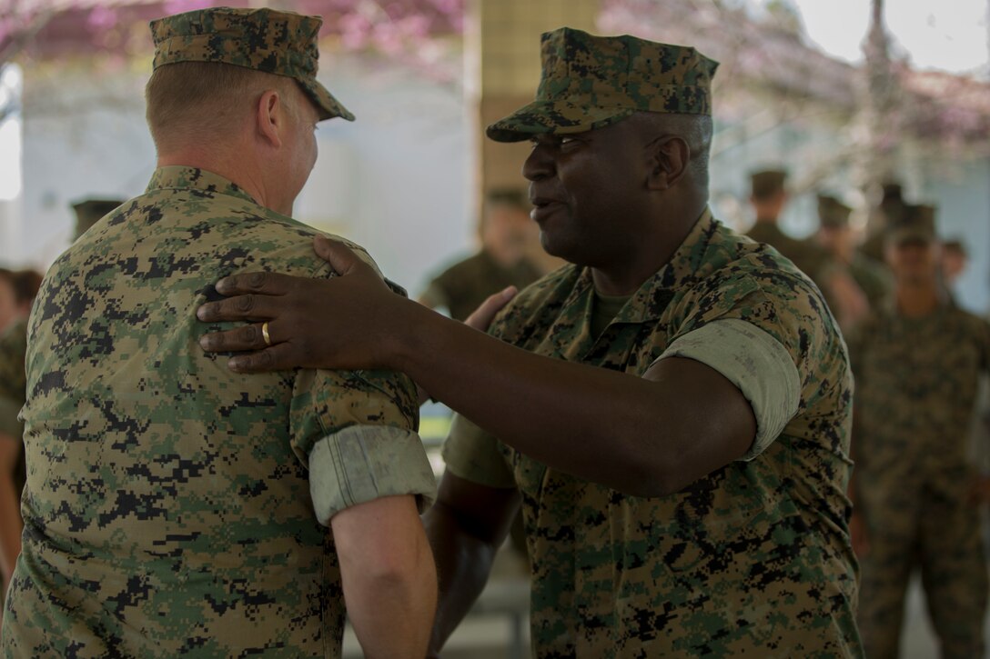 Sgt. Maj. Alfred R. Broadus, Recruiting Station sergeant major, RS Orlando, Fla., shakes hands with Marines attending his final reenlistment at Marine Corps Base Camp Pendleton, Calif., March 22, 2017. Twenty two years ago, Col. Roberta Shea, commanding officer of I Marine Expeditionary Force Headquarters Group, had the honor of being his first reenlistment officer and now his last. (U.S. Marine Corps photo by Lance Cpl. A. J. Van Fredenberg)