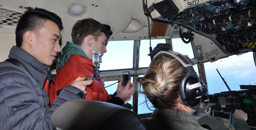 Two Air Force Junior Reserve Officer Training Corps (JROTC) Cadets take pictures on the flight deck of a C-130H Hercules during an orientation flight March 22, 2017. The cadets are with AFJROTC PA-931 at Cathedral Preparatory School, Erie, Pennsylvania. The purpose of the event was to show the cadets some opportunities in the Air Force Reserve. (U.S. Air Force photo/Maj. Polly Orcutt)