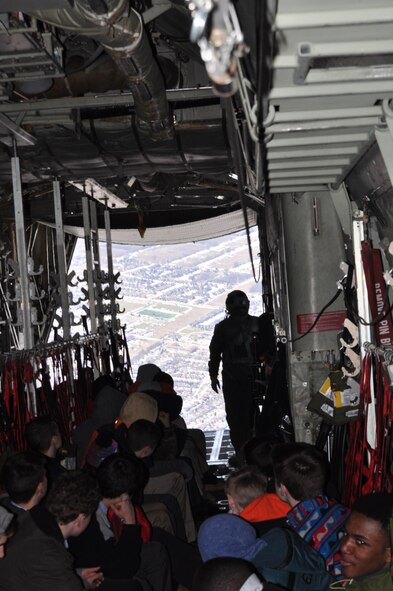 Air Force Junior Reserve Officer Training Corps (JROTC) Cadets look out of the back of a C-130H Hercules as it flies over Niagara Falls, New York, during an orientation flight March 22, 2017. The cadets are with AFJROTC PA-931 at Cathedral Preparatory School, Erie, Pennsylvania. The purpose of the event was to show the cadets some opportunities in the Air Force Reserve. (U.S. Air Force photo/Maj. Polly Orcutt)
