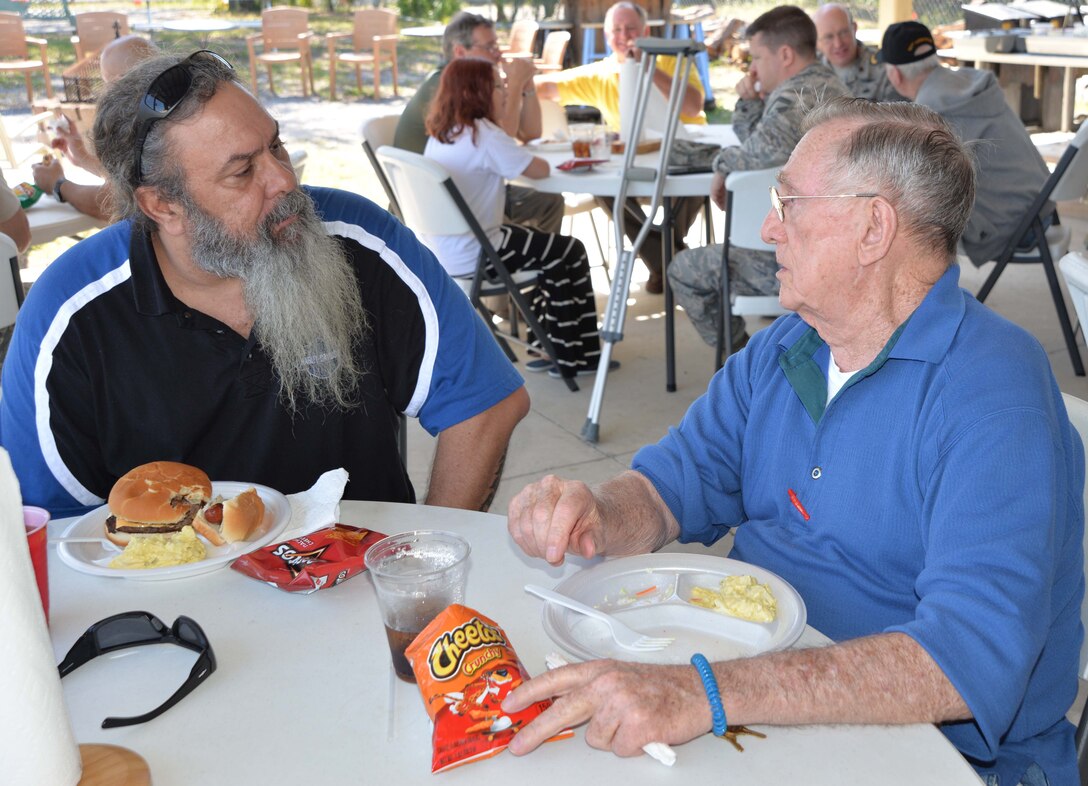 David Shaw, Continental U.S. NORAD Region-1st Air Force (Air Forces Northern) Communication & Information Directorate, talks with John Milan, a resident of the Clifford Chester Sims State Veterans Nursing Home, during a luncheon at American Legion Post 392 in Panama City. Shaw, a Legion member who organized the luncheon, said the event was an opportunity to spend time with the veterans and recognize them for their selfless service and sacrifice. (Photo by Mary McHale)