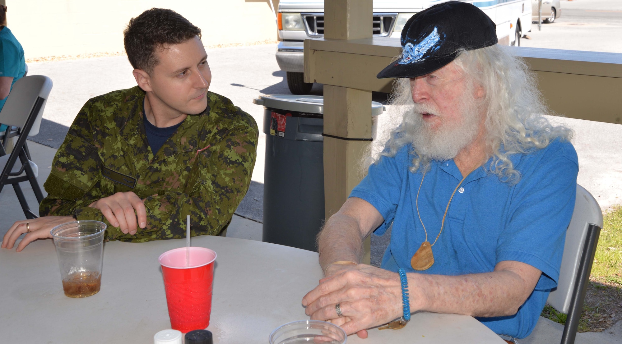 Royal Canadian Air Force Sgt Evan Ryan, Continental U.S. NORAD Region-1st Air Force (Air Forces Northern) Communication & Information Directorate, talks with Dennis Belk, a resident of the Clifford Chester Sims State Veterans Nursing Home, during a luncheon at American Legion Post 392 in Panama City. Event organizer David Shaw, a Legion member from CONR-1st AF (AFNORTH), said the luncheon was an opportunity to spend time with the veterans and recognize them for their selfless service and sacrifice. (Photo by Mary McHale)