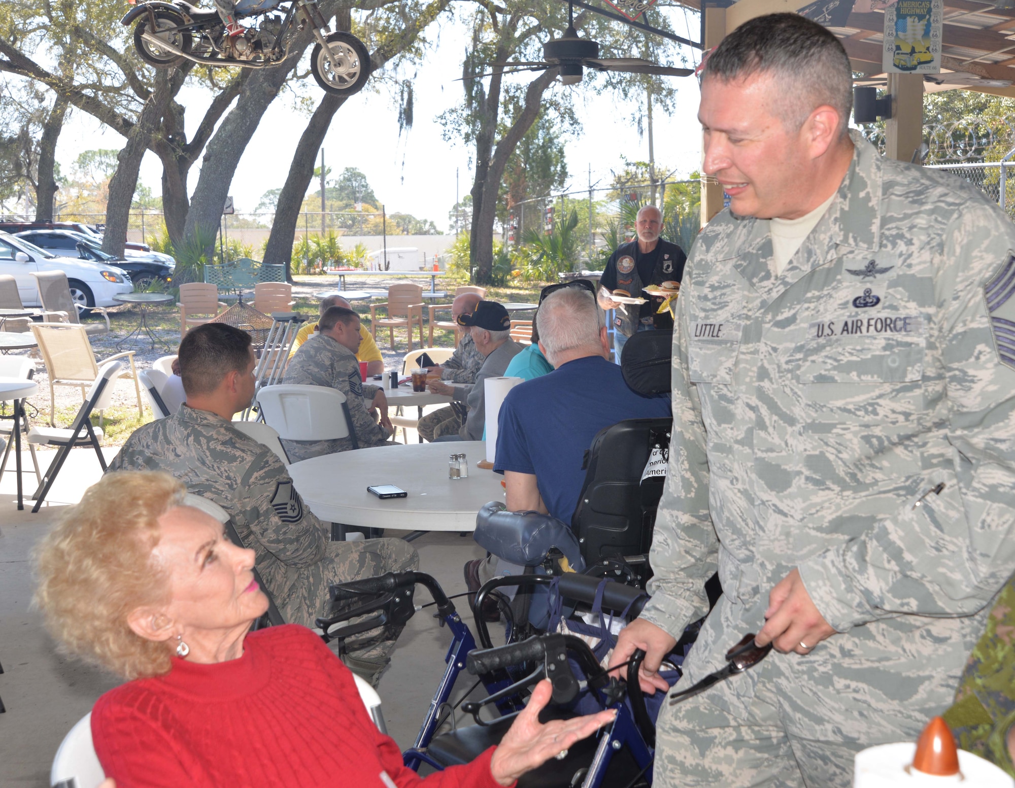 Maxine Mann, a resident of the Clifford Chester Sims State Veterans Nursing Home, talks with Chief Master Sgt. David Little, Senior Enlisted Leader, Continental U.S. NORAD Region-1st Air Force (Air Forces Northern) Communication & Information Directorate, during a luncheon at American Legion Post 392 in Panama City. Event organizer David Shaw, a Legion member from CONR-1st AF (AFNORTH), said the luncheon was an opportunity to spend time with the veterans and recognize them for their selfless service and sacrifice. (Photo by Mary McHale)


