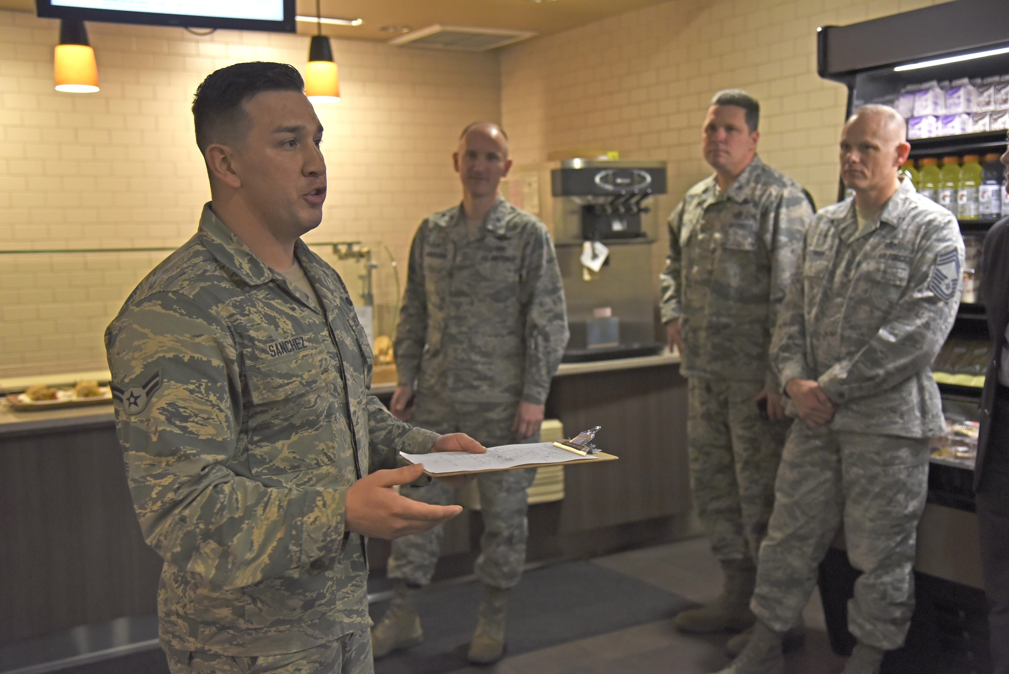 Airman 1st Class Eric Sanchez, 92nd Force Support Squadron services journeyman, talks with base leadership about the healthier, made-to-order Super Sonic Subs Mar. 27, 2017, at Fairchild Air Force Base, Washington. Base leadership gathered to taste test the Warrior Mission Essential Feeding Facility's new concepts. (U.S. Air Force photo/Senior Airman Mackenzie Richardson)