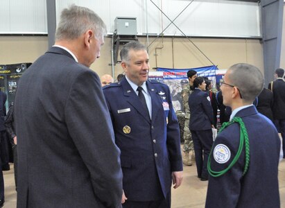 Brig. Gen. Mitchel Butikofer, 24th Air Force Vice Commander, converses with a Junior Reserve Officer Training Corps student during an information fair at the Mayor's Cyber Cup banquet March 25 in San Antonio, Texas. Over 1,000 attendees were able to learn about opportunities in fields related to science, technology, engineering and math.
