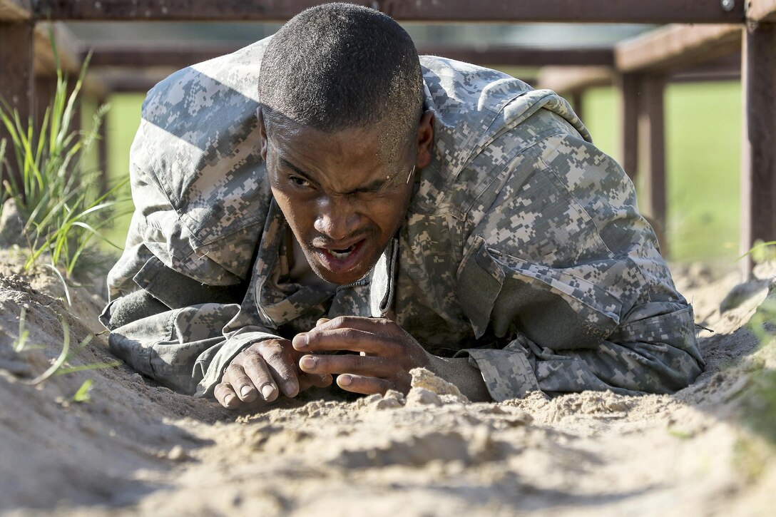 Army Spc. Michael Parrish Jr. tackles the low-crawl obstacle during the 108th Training Command's Best Warrior Competition at Camp Bullis, Texas, March 20, 2017. Parrish, a human resources specialist assigned to the 104th Training Division's Alpha Company, 2nd Battalion, 319th Artillery Regiment, earned the title of 2017 Soldier of the Year for the division. Army Reserve photo by Maj. Michelle Lunato