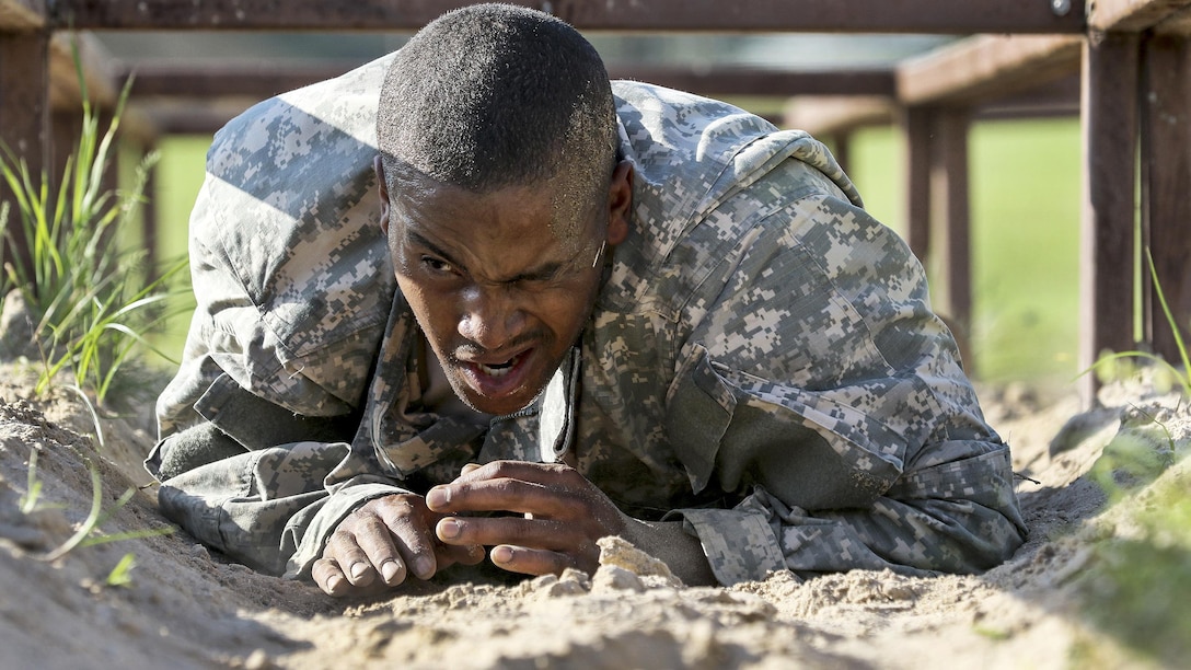 Army Spc. Michael Parrish Jr. tackles the low-crawl obstacle during the 108th Training Command's Best Warrior Competition at Camp Bullis, Texas, March 20, 2017. Parrish, a human resources specialist assigned to the 104th Training Division's Alpha Company, 2nd Battalion, 319th Artillery Regiment, earned the title of 2017 Soldier of the Year for the the division. Army Reserve photo by Maj. Michelle Lunato