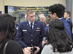 First Lt. Eric Kenney, 390th Cyberspace Operations Center, speaks with high schoolers about the Air Force cyber mission during an information fair at the annual Mayor's Cyber Cup banquet March 25 in San Antonio, Texas. The students all competed in the Air Force Association CyberPatriot challenge, a nationwide program in which teams of students learn to harden network security and then compete to defend systems against intrusions.  