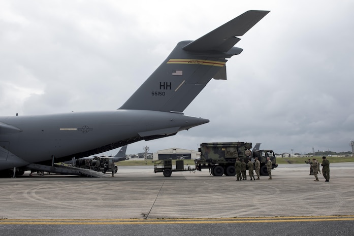 Japan Ground Self-Defense Force members observe Soldiers of the 1st Battalion, 1st Air Defense Artillery Regiment load Patriot missile battery equipment onto a C-17 Globe Master III March 14, 2017, on Kadena Air Base, Japan. The Patriot missile system is a long-range air defense asset and can be broken down to be transported via plane anywhere in the world in a matter of hours.