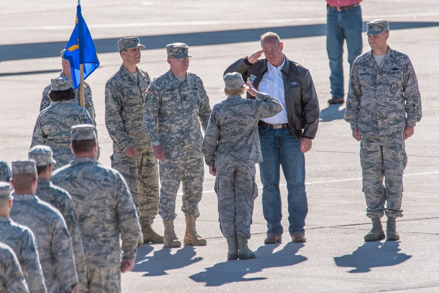 Col. Shelley Campbell, then 153rd Mission Support Group commander and now Chief of the Joint Staff, salutes commander in chief of the Wyoming National Guard, Gov. Matt Mead, during a pass-in-review ceremony at the 153rd Airlift Wing, Cheyenne, Wyoming, July 2015. (Photo by Master Sgt. Charles Delano)