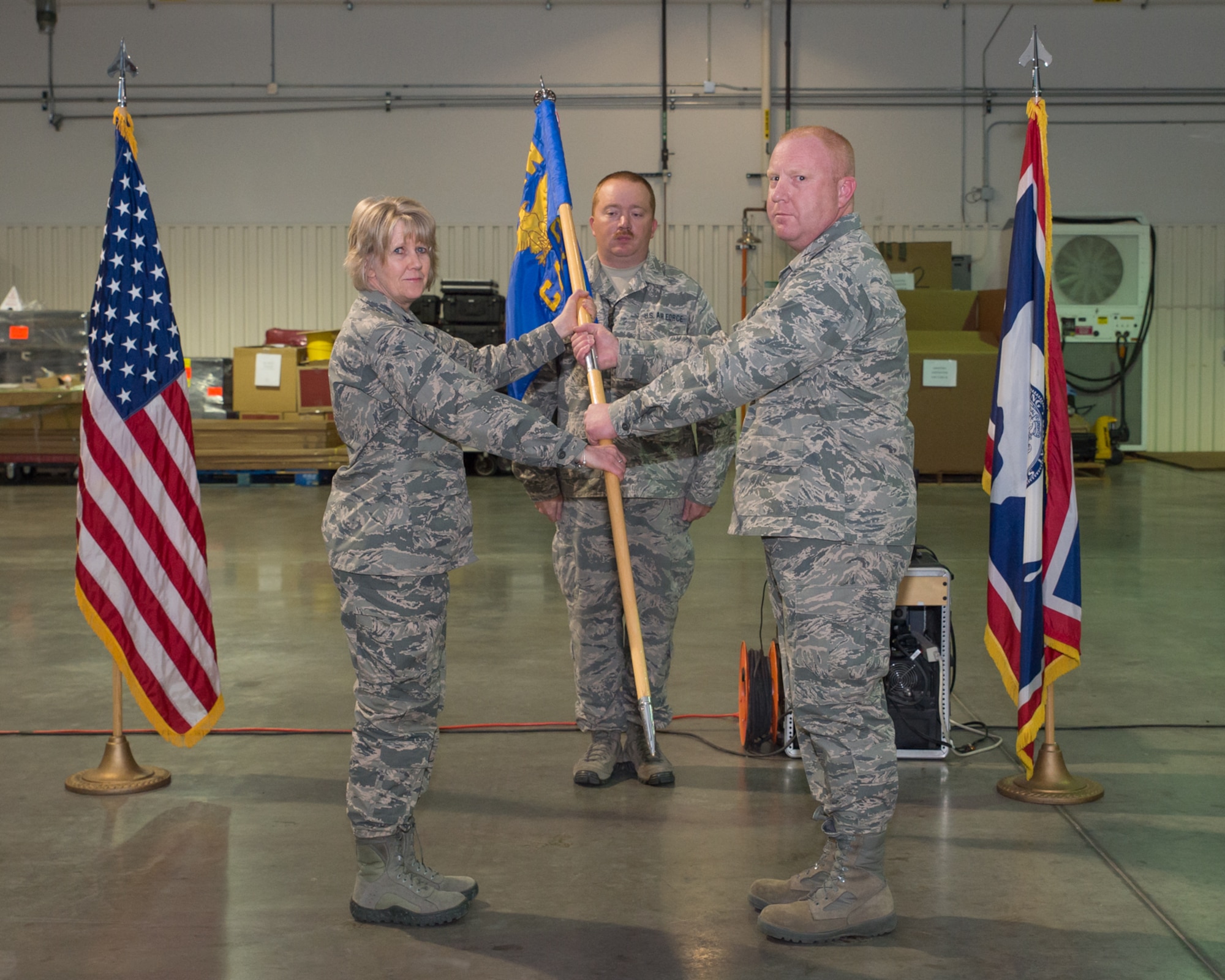 153rd Mission Support Group Commander Col. Shelley Campbell passes the 153rd Command and Control Squadron guidon to incoming commander Lt. Col. Christopher Howard at an Assumption of Command ceremony, Sept. 29, 2015 at F.E. Warren AFB in Cheyenne, Wyoming. Howard has previously held a position as the commander of the 243rd Air Traffic Control Squadron. (U.S. Air National Guard photo by Master Sgt. Charles Delano/released)