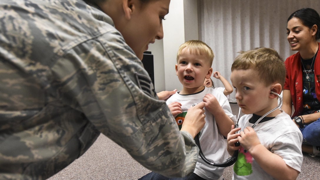 Air Force Senior Airman Elenacorozal Denny teaches children from the 4th Force Support Squadron Child Development Center how to use a stethoscope at Seymour Johnson Air Force Base, N.C., March 21, 2017. The children listened to each other’s heartbeats, read books about the body and toured the pediatric clinic. Air Force photo by Airman 1st Class Victoria Boyton