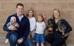 Maj. Sean Maday, assigned as an instructor at the Headquarters Reserve National Security Space Institute at Peterson Air Force Base, Colo., poses with his family for a photo. Maday channeled his family’s love of language and reading into a story that he hopes many others can now enjoy when he published his first children's book. (Courtesy photo)