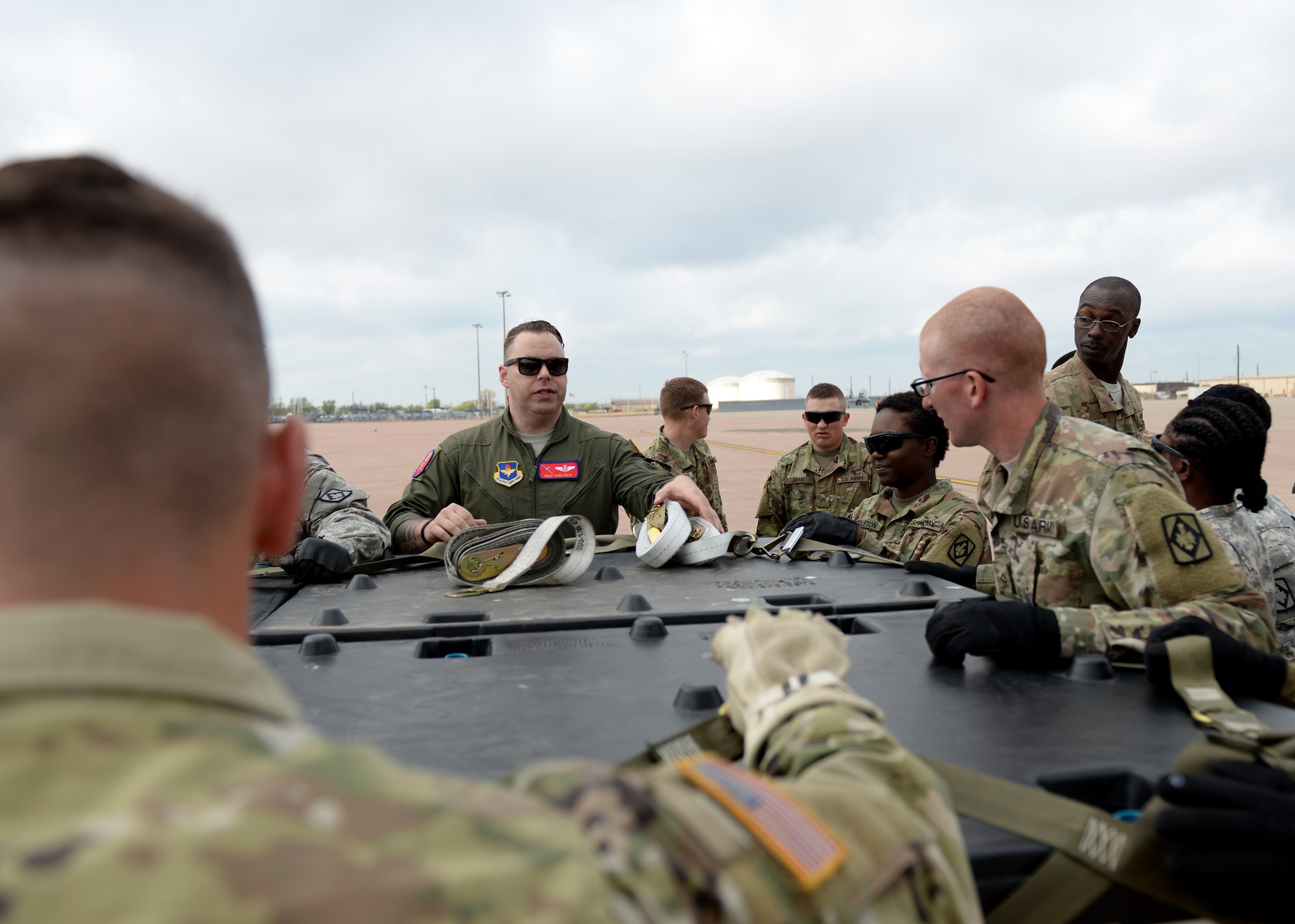 U.S. Air Force Master Sgt. Edwin Amos, 58th Airlift Squadron instructor loadmaster, educates U.S. Army Soldiers assigned to the 578th Forward Support Company at Fort Sill, Oklahoma, about the weight restrictions of the straps, March 23, 2017, at Altus Air Force Base, Oklahoma. The soldiers came to Altus AFB to learn how to secure cargo pallets and vehicles to a U.S. Air Force C-17 Globemaster III cargo aircrafts. (U.S. Air Force photo by Airman 1st Class Jackson N. Haddon/Released).