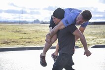 Participants complete a 100 meter fireman's carry at the 2017 Maltz Challenge. (U.S. Air Force photo/2nd Lt. Katherine Miranda)