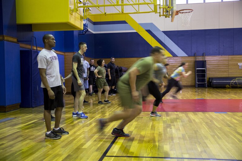 U.S. Marines in the Force Fitness Instructors program do warm-up drills on the final day of an eight-week physical training course at Marine Corps Air Station Iwakuni, Japan, March 17, 2017. These Marines were the first to take the course at MCAS Iwakuni. The recently implemented Force Fitness Instructors are capable of designing individual and unit-level holistic fitness programs, and they serve as subject matter experts on physical fitness and sports-related injury prevention. (U.S. Marine Corps photo by Lance Cpl. Carlos Jimenez)