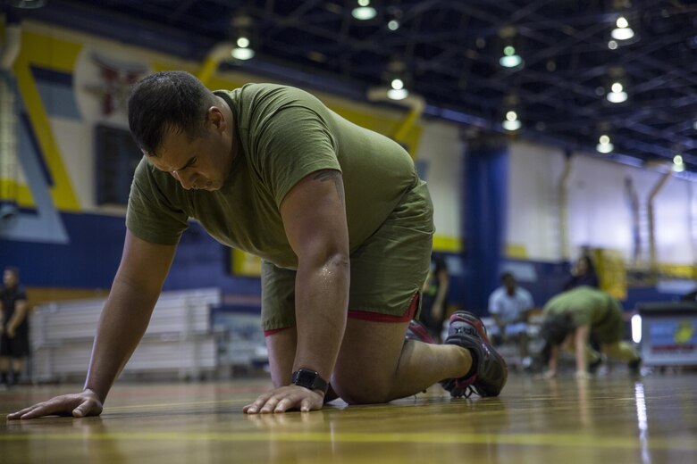 U.S. Marine Corps Sgt. Mikael Merrick, an anti-terrorism officer with the Provost Marshals Office, does physical training on the final day of an eight-week course led by Force Fitness Instructors at Marine Corps Air Station Iwakuni, Japan, March 17, 2017. Merrick was part of the first group of Marines to undergo the course at MCAS Iwakuni. The recently implemented Force Fitness Instructors are capable of designing individual and unit-level holistic fitness programs, and they serve as subject matter experts on physical fitness and sports-related injury prevention.