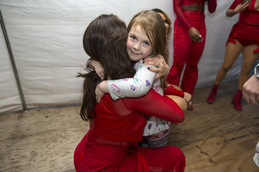 Fifth Harmony member, Lauren Jauregui, hugs a young fan during a meet and greet before their concert March 23 aboard Camp Foster, Okinawa, Japan. Approximately 9,500 people attended this concert, including service members, local Okinawa residents and fans who travelled from mainland Japan. They performed a few of their top hits including, “BO$$,” “Work From Home,” and “That’s My Girl.”
