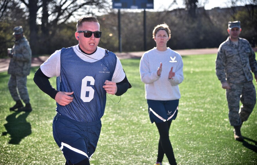 Senior Airman Joseph Shaffer, 932nd Maintenance Squadron C40-C crew chief, completes the 1.5 mile aerobic assessment of the Air Force fitness test March 3, 2017, at the Scott Air Force Base James Gym track.  Captain Liz Wszalek, 932nd Force Support Squadron and a group leader for the Scott Health Promotions Running Clinic was there to cheer on Shaffer as he finished the run.  Shaffer participated in the running clinic to improve his run time and was in Wszalek's group. "I went from a 13:40 to a 12:08 in less than 7 weeks and scored a 93% for my test," said Shaffer. Shaffer then added that although the clinic was challenging to start, it got easier and highly recommends it to anyone that wants to improve their run time.  (U.S. Air Force photo by Tech. Sgt. Christopher Parr) 